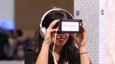 Woman using virtual reality headset at a corporate tradeshow Stock Footage 56370477