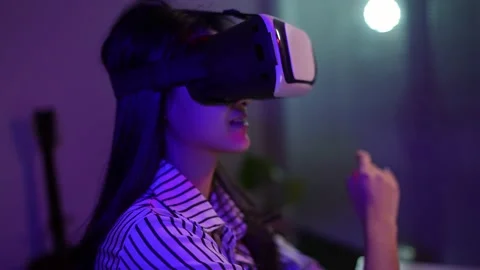 Woman using virtual reality headset and looking around at interactive technology Видео 149964119