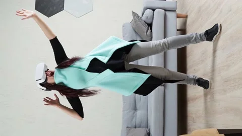 Woman is using virtual reality headset. Vertical video. Stock Footage 157809532