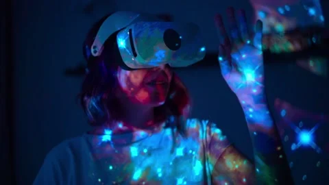 Woman is using virtual reality headset. Elements of this image furnished by NASA Stock Footage 191887634