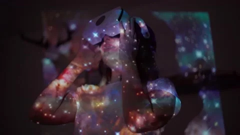 Woman is using virtual reality headset. Elements of this image furnished by NASA Stock Footage 191888358