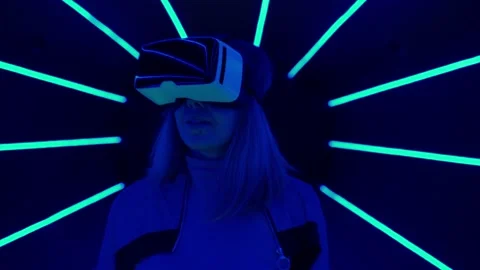 Woman is using virtual reality headset to access in metaverse. Stock Footage 210294273