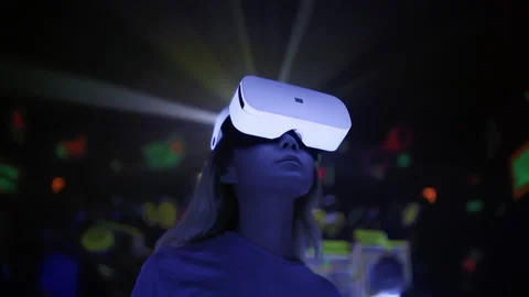Woman using virtual reality headset at interactive technology exhibition Stock Footage 230446534