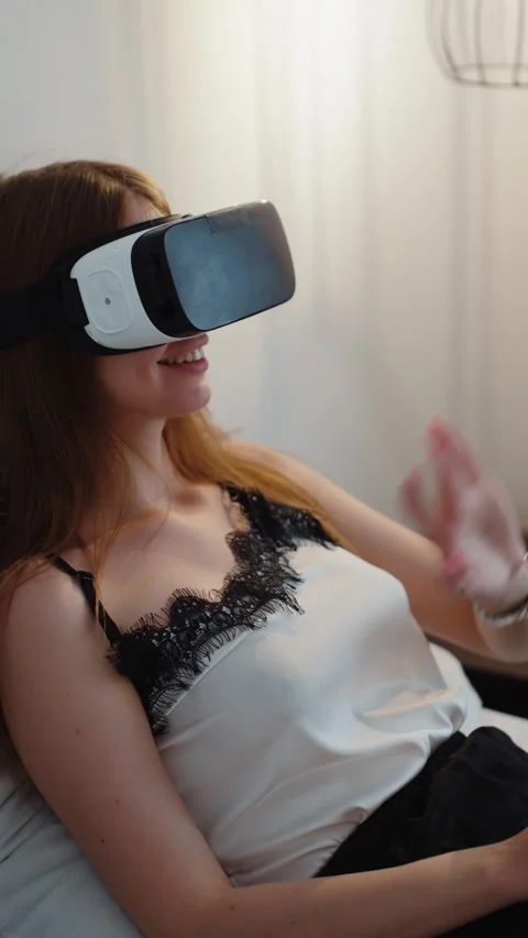 Woman Using Virtual Reality Headset While Lying on Bed Video stock 323090398