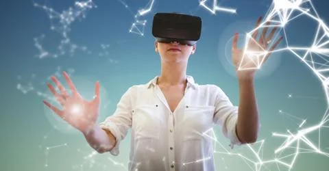 Woman using virtual reality headset against sky Stock Photos