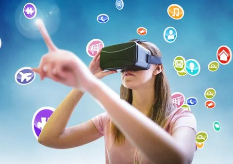 Woman using virtual reality headset with digitally generated icons Stock Photos