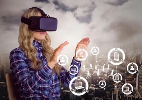 Woman using virtual reality headset with digitally generated icons Stock Photos