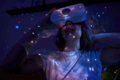 Woman is using virtual reality headset. Elements of this image furnished by NASA Stock Photos
