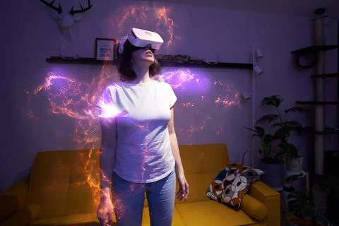 Woman is using virtual reality headset. Elements of this image furnished by NASA Stockfoto's