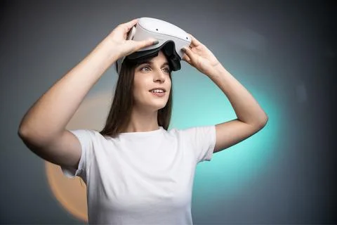 Woman using a virtual reality headset isolated on colorful background Stock Photos