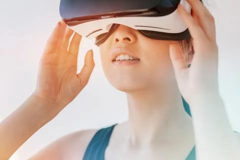Woman using the virtual reality headset and looking away Stock Photos