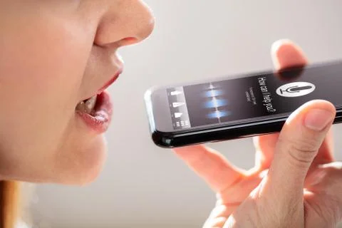 Woman Using Voice Recognition Function On Mobile Phone Stock Photos