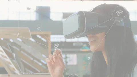Woman using VR headset raising finger, activating network nodes above laptop, Stock Footage 333632249