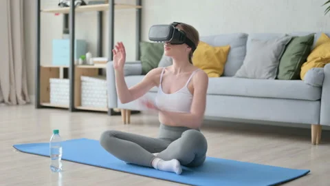 Woman using VR Set with Sitting on Yoga Mat Stock Footage 154845357