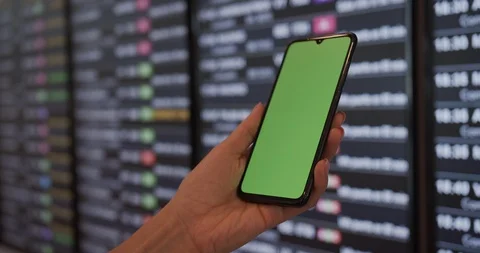 Woman using white mobile device with green screen in terminal hall while waiting Stock Footage 119030358