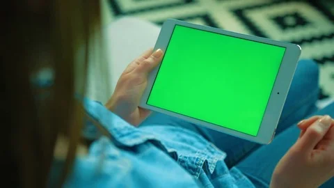 Woman using white tablet device with green screen. Woman holding tablet Stock Footage 76375742