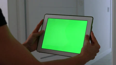 Woman using white tablet device with green screen. Woman holding tablet Stock Footage 219792835