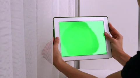 Woman using white tablet device with green screen. Woman holding tablet Stock Footage 219792859