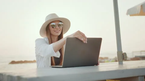 Woman using wireless laptop for remote work near sea Video stock 163619187