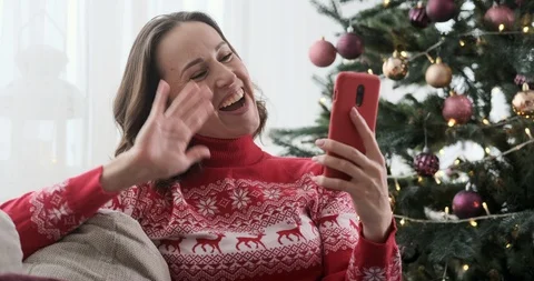 Woman video calling using mobile phone during Christmas Stock Footage 129423662