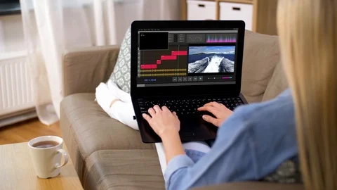 Woman with video editor program on laptop at home Stock Footage 108735687
