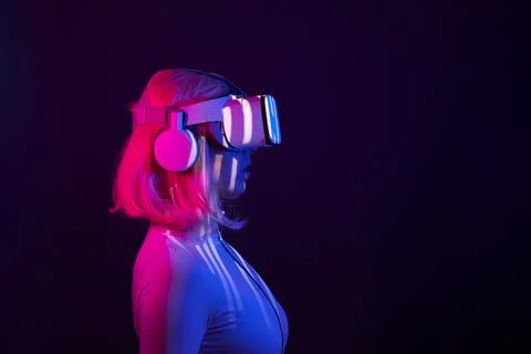 Woman in virtual reality goggle in neon colors. Stock Photos