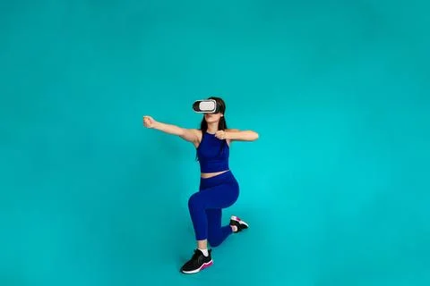Woman with vr glasses simulating using bow and arrow. Stock Photos