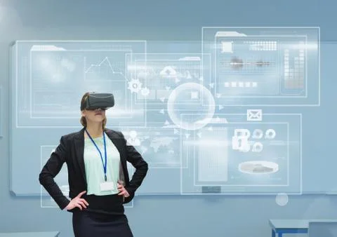 Woman in VR headset looking at interface against blue background with interfaces Stock Photos