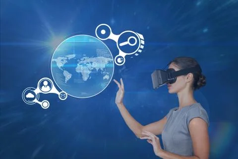 Woman in VR headset touching interface against blue background with flares 스톡 사진