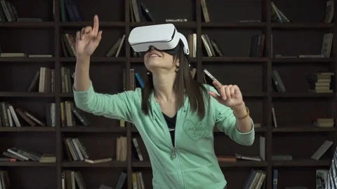 Woman in vr headset touching a virtual screen Stock Footage 74598536