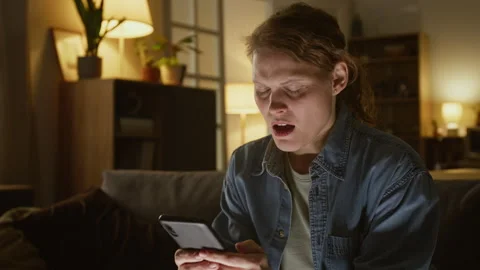 Woman Wailing in Panic after Receiving Money Transfer Alerts from Bank Stock Footage 329052598