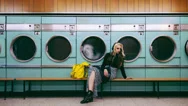 Woman Waiting For Laundry At Launderette Cinemagraph Seamless Loop Stock Footage