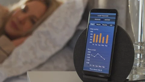 Woman Waking Up In Bed And Checking Sleep Data App Running On Mobile Phone On Stock Footage 124588175