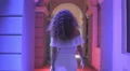 The woman walk along the column. Night evening time. Wide angle. Real time 4k or 4k+ Resolution