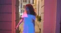 The woman walk along the column. Night evening time. Wide angle. Real time 4k or 4k+ Resolution