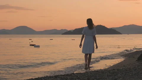 Woman Walking Alone on Beach at Sunset Stock Footage 282933045