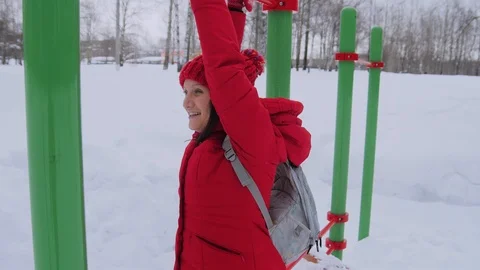 Woman walking alone in winter landscape in moody weather hiking girl wearing red Stock Footage 101782553