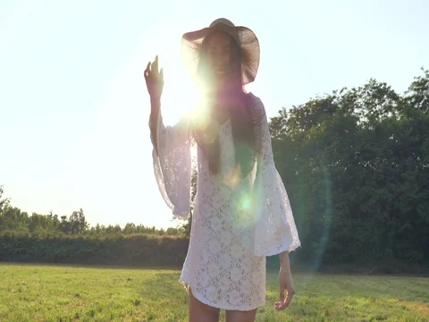 A woman is walking along a wheat field with a white dress Stock Footage