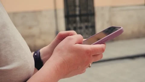 Woman walking and using a smartphone on the street in European city. Tourist Stock Footage 323217048