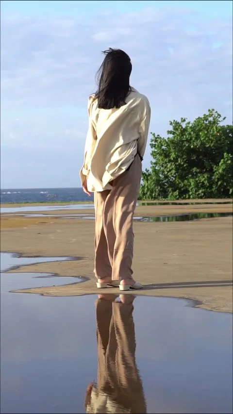 Woman Walking on Beach with Reflection Stock Footage 283199449