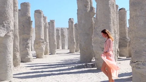 Woman walking between columns Stock Footage 76181681