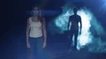 The woman walking in a dark street against a man in a smoke background 4k or 4k+ Resolution
