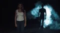 The woman walking in a dark street on a man silhouette background. slow motion 4k or 4k+ Resolution