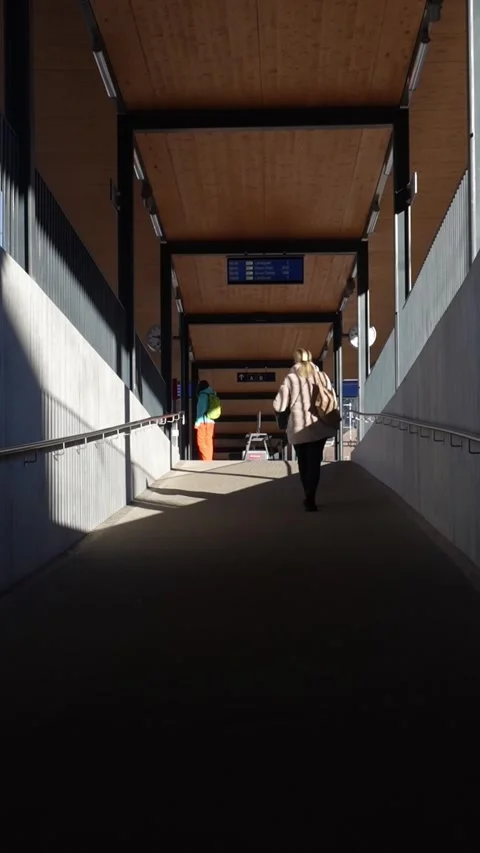 Woman walking down a modern train station ramp 스톡 동영상 329667817