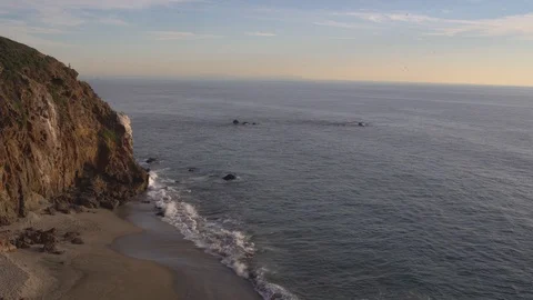 Woman walking down a path, overlooking ocean from a cliff, 4k Stock Footage 103437354