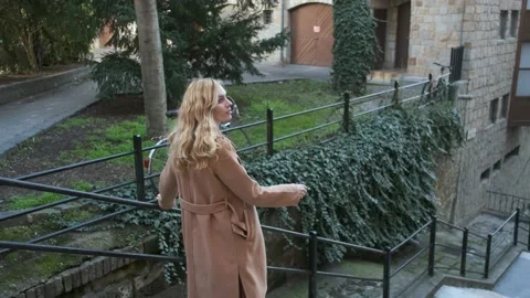 Woman walking down the stairs of an old european city Stock Footage 143641853