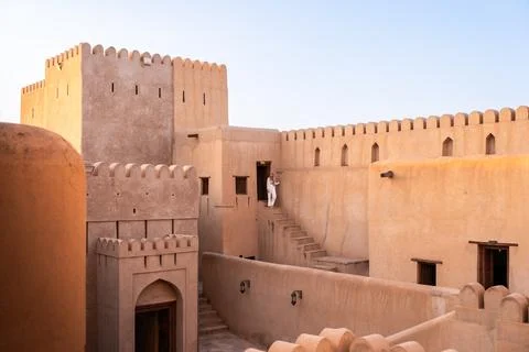 Woman walking down steps inside the historic nizwa fort in oman Stock Photos