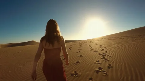 Woman walking on dune Stock Footage