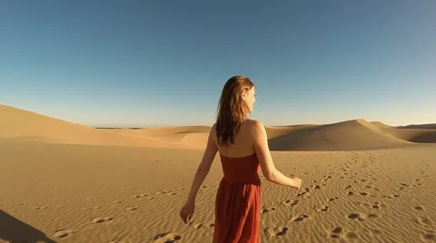 Woman walking on dune Stock Footage