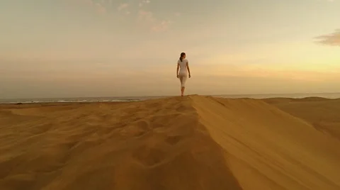 Woman walking on dunes Stock Footage